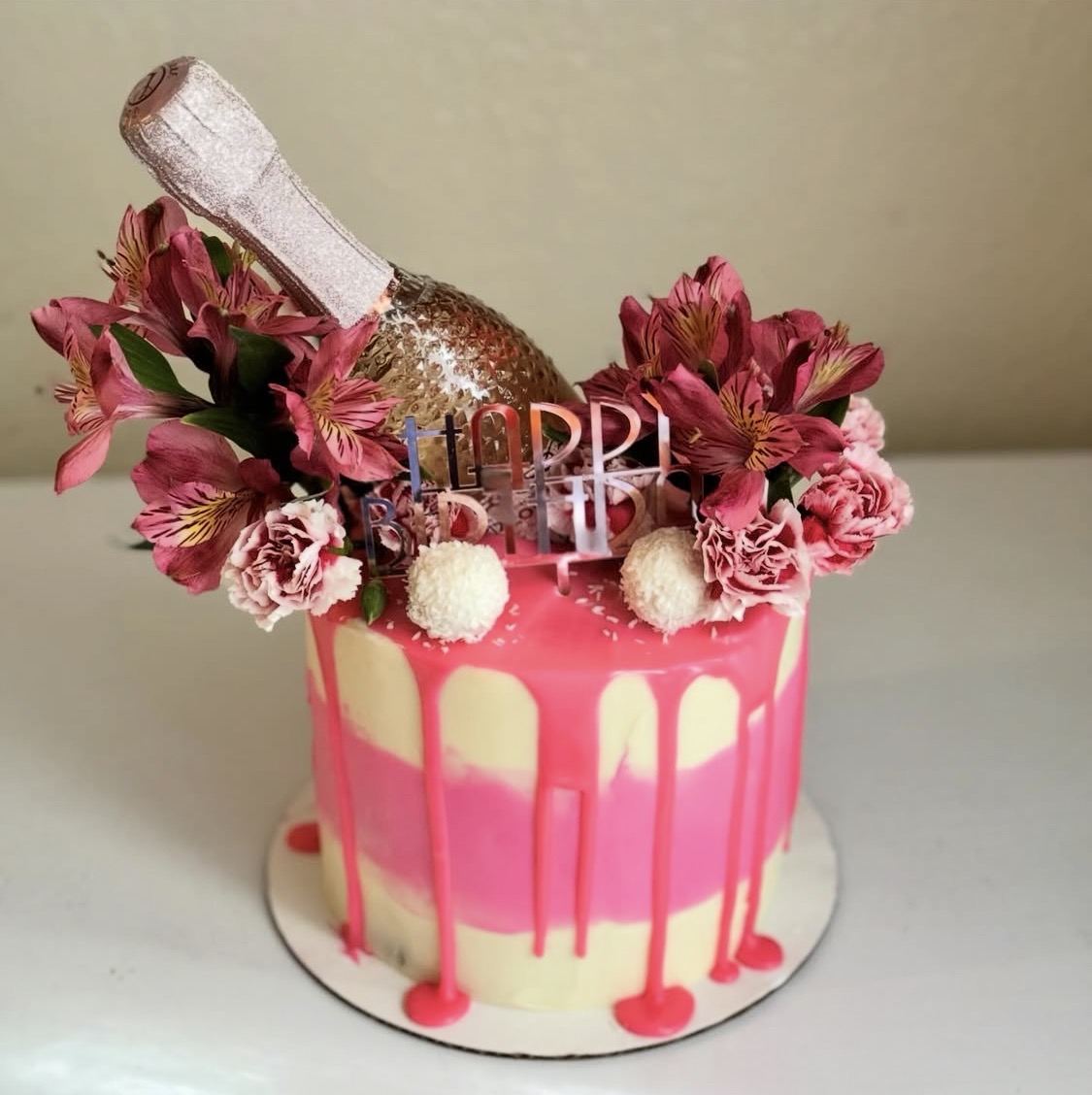 Pink bottle celebration cake